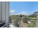 Relaxing balcony features metal railings and furniture with views of the city and neighborhood street at 2530 Lawrence St # Ra301, Denver, CO 80205