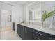 Bathroom features a modern vanity with quartz counters and illuminated mirror at 2530 Lawrence St # Ra301, Denver, CO 80205