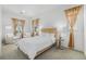 Bright bedroom with warm wood accents, natural light, and sitting area at 2530 Lawrence St # Ra301, Denver, CO 80205