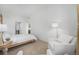 Bright bedroom features clean white decor, and cozy sitting area at 2530 Lawrence St # Ra301, Denver, CO 80205