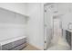 Walk-in closet with custom shelving and bench with soft-close drawers at 2530 Lawrence St # Ra301, Denver, CO 80205