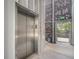 An indoor elevator adjacent to a brick wall and exit to the exterior of the building at 2530 Lawrence St # Ra301, Denver, CO 80205