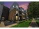 Beautiful exterior of a multi-story townhome with a brick facade and metal roof at sunset at 2530 Lawrence St # Ra301, Denver, CO 80205