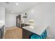 Bright, modern kitchen with stainless steel appliances, island seating, and view to the living room at 2530 Lawrence St # Ra301, Denver, CO 80205