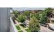 A view from the balcony of a neighborhood street, showing trees, cars and the surrounding area at 2530 Lawrence St # Ra301, Denver, CO 80205