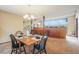 Bright dining room with a wood table and four chairs, offering a view of the living room at 18585 Augusta Dr, Monument, CO 80132