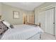 Comfortable bedroom featuring a neutral color palette, a queen sized bed and double door closet at 581 Stonemont Dr, Castle Pines, CO 80108