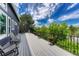 Spacious deck with black railing overlooking lush greenery and blue skies. Offers ample seating at 581 Stonemont Dr, Castle Pines, CO 80108
