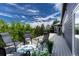 Spacious deck with seating overlooking beautiful trees and foliage at 581 Stonemont Dr, Castle Pines, CO 80108