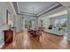 Elegant dining room showcasing coffered ceilings, hardwood floors, and modern lighting at 581 Stonemont Dr, Castle Pines, CO 80108