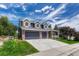 Charming home showcasing a spacious three car garage and well-manicured lawn at 581 Stonemont Dr, Castle Pines, CO 80108