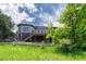 Exterior rear view of a home featuring a spacious deck, bay window, and landscaped yard at 581 Stonemont Dr, Castle Pines, CO 80108