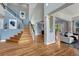 Inviting foyer featuring hardwood floors, staircase, and a view into the living area at 581 Stonemont Dr, Castle Pines, CO 80108