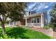 Charming home with inviting front porch and lush landscaping at 581 Stonemont Dr, Castle Pines, CO 80108