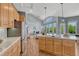 Open concept kitchen with center island, breakfast bar, and view into the living room at 581 Stonemont Dr, Castle Pines, CO 80108