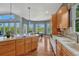 Bright, open kitchen with center island, stainless steel appliances, and access to outdoor patio at 581 Stonemont Dr, Castle Pines, CO 80108