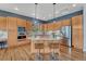 Well-equipped kitchen with island, breakfast bar, stainless steel appliances, and ample cabinetry at 581 Stonemont Dr, Castle Pines, CO 80108