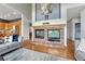 Open living space with brick fireplace, TV, and seamless flow to kitchen and dining at 581 Stonemont Dr, Castle Pines, CO 80108