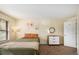 Sunlit bedroom features a cozy bed, stylish nightstand, and natural light from window at 2 Acoma St # 11, Denver, CO 80223