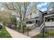 Inviting townhouse with a neat front yard and a classic gray exterior at 2 Acoma St # 11, Denver, CO 80223