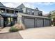 Apartment building with garages, landscaping, and walkway at 2 Acoma St # 11, Denver, CO 80223