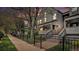 Charming townhouse with gray siding, a cozy porch, and a manicured front yard at 2 Acoma St # 11, Denver, CO 80223