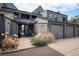 Contemporary townhome featuring attached two-car garage and private entrance surrounded by lush, xeriscaped landscaping at 2 Acoma St # 11, Denver, CO 80223
