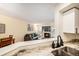 Partial view of open floor plan highlighting the kitchen and living room with fireplace at 2 Acoma St # 11, Denver, CO 80223
