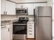 Well-equipped kitchen with stainless steel appliances and bright white cabinetry at 2 Acoma St # 11, Denver, CO 80223