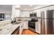 Modern kitchen featuring stainless steel appliances, white cabinets, and granite countertops at 2 Acoma St # 11, Denver, CO 80223