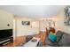 Inviting living room with a gray sofa, wood floors, and a dining area nearby at 2 Acoma St # 11, Denver, CO 80223