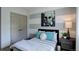 Cozy bedroom with gray and white striped walls, and bed with plush throw and accent pillows at 23451 E Rockinghorse Pkwy, Aurora, CO 80016