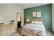 Cozy bedroom featuring a comfortable bed, warm tones, and access to the bathroom at 23451 E Rockinghorse Pkwy, Aurora, CO 80016