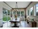 Elegant dining room with stylish lighting, large windows, and hardwood floors at 23451 E Rockinghorse Pkwy, Aurora, CO 80016