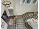 Open-concept entryway featuring a stylish staircase, hardwood floors, and modern decor at 23451 E Rockinghorse Pkwy, Aurora, CO 80016