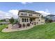 Charming home showcasing a manicured lawn, gravel landscaping, and a cozy covered patio, enhancing the overall curb appeal at 23451 E Rockinghorse Pkwy, Aurora, CO 80016