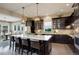 Modern kitchen featuring a large central island, sleek cabinetry, and stainless steel appliances at 23451 E Rockinghorse Pkwy, Aurora, CO 80016