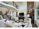 Cozy living room with high ceilings, fireplace and staircase at 23451 E Rockinghorse Pkwy, Aurora, CO 80016
