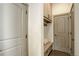 Functional mudroom with built-in bench, storage cabinets, and convenient access to other areas at 23451 E Rockinghorse Pkwy, Aurora, CO 80016