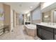 Bright bathroom with dual sinks, soaking tub, and walk-in shower with neutral color palette at 11879 W Portland Dr, Littleton, CO 80127