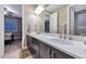 Elegant bathroom featuring dual sinks, quartz countertops, and modern fixtures with great lighting at 11879 W Portland Dr, Littleton, CO 80127