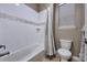 Well-maintained bathroom featuring a tiled shower-tub combination and modern toilet at 11879 W Portland Dr, Littleton, CO 80127