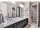 Clean, well-maintained bathroom featuring dual sinks, with quartz countertops and modern lighting at 11879 W Portland Dr, Littleton, CO 80127