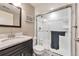 Modern bathroom with granite countertops, sink, toilet, and glass-enclosed shower at 11879 W Portland Dr, Littleton, CO 80127