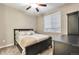 Cozy bedroom with large window, plush carpet, and a ceiling fan creating a relaxing atmosphere at 11879 W Portland Dr, Littleton, CO 80127