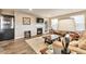 Cozy living room featuring a fireplace, large windows for natural light, and comfortable seating at 11879 W Portland Dr, Littleton, CO 80127