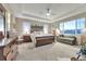 Spacious main bedroom featuring a tray ceiling, natural light, and an en-suite bathroom at 11879 W Portland Dr, Littleton, CO 80127