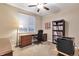 Home office with traditional wood desk, chair, and bookcase for a professional workspace at 11879 W Portland Dr, Littleton, CO 80127