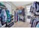 Spacious walk-in closet with custom shelving for ample storage and easy organization of clothing at 11879 W Portland Dr, Littleton, CO 80127