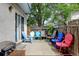 Inviting backyard patio with a variety of colorful chairs, grill, and wood fence at 2213 Emery St # C, Longmont, CO 80501